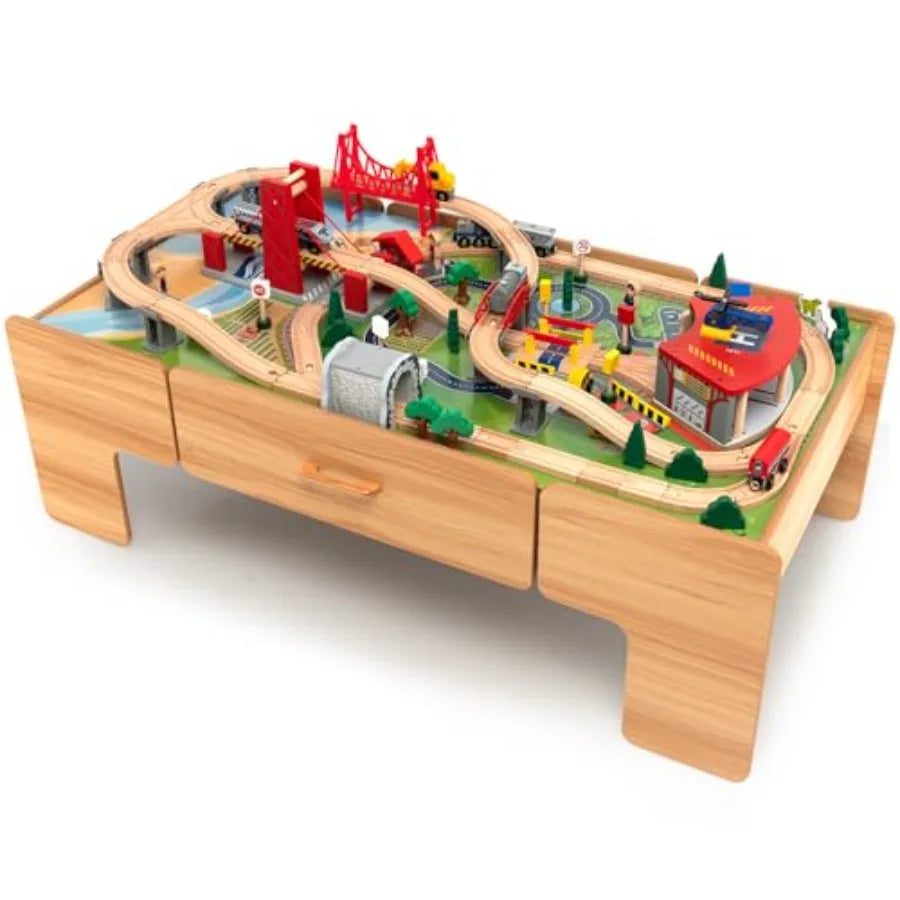 Tavolo ferroviario per la stanza dei giochi dei bambini, in legno con finitura naturale, dotato di piano ribaltabile, cassetto portaoggetti e tracciato ferroviario.